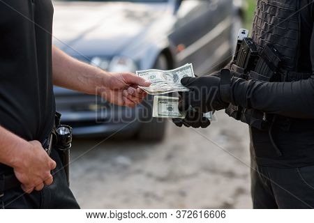The Offender Gives Money To The Police Officer. Stop Corruption And Bribes. A Corrupt Policeman Taki