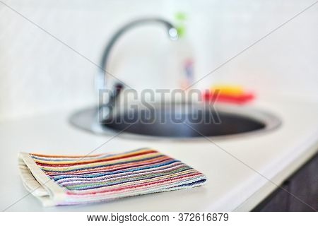 Kitchen Towel And Sink Without Dirty Dishes Background. Dishcloth On Kitchen Countertop. Cleaning An