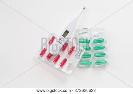 Digital Thermometer About Red And Green Pills