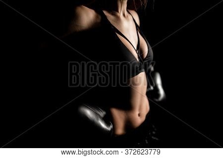 Female Boxer Training In The Dark Ring. Silhouette. Boxing Concept. Fighter Woman Fist Close Up. Sex
