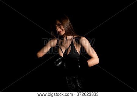 Female Boxer Training In The Dark Ring. Silhouette. Boxing Concept. Fighter Woman Fist Close Up. Sex