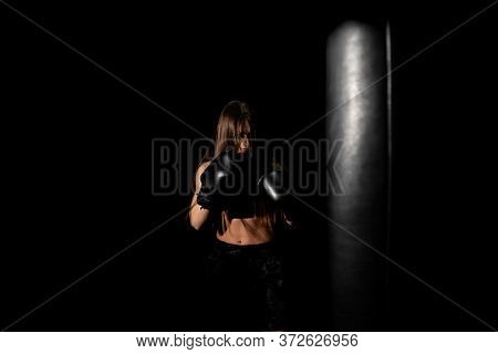 Female Boxer Training In The Dark Ring. Silhouette. Boxing Concept. Fighter Woman. Sexy Girl With Pe