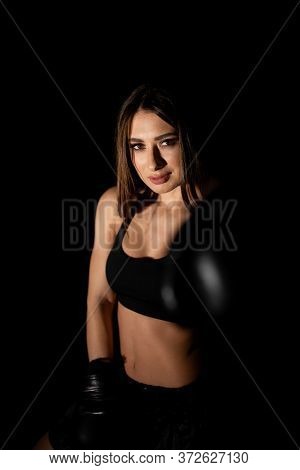 Female Boxer Training In The Dark Ring. Silhouette. Boxing Concept. Fighter Woman Fist Close Up. Sex