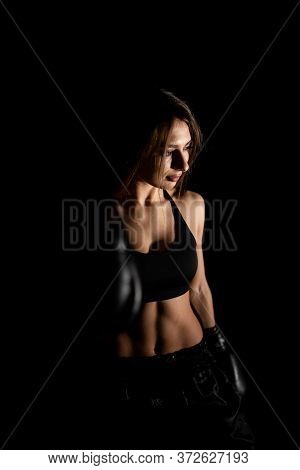 Female Boxer Training In The Dark Ring. Silhouette. Boxing Concept. Fighter Woman Fist Close Up. Sex