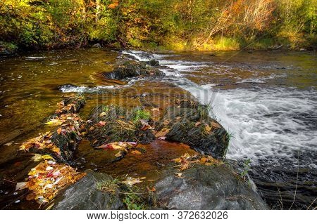 Fall Color Landscape. Waterfall Along The Falls River In Baraga, Michigan.