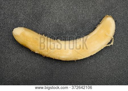 Overripe Unskin Banana On A Dark Background
