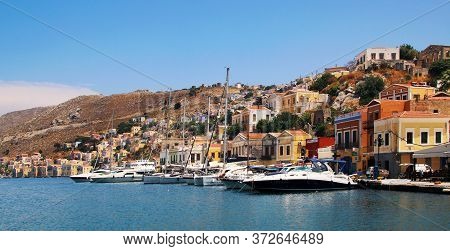 Symi, Greece - June 21, 2020: Symi Town, Symi Island, Pictorial View Of Colorful Houses And  Yialos 