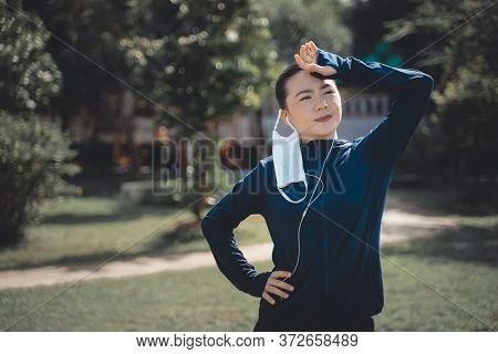 Portrait Of Asian Woman Workout Before Running At Village Park. Cheerful Runner Stretching And Warmi