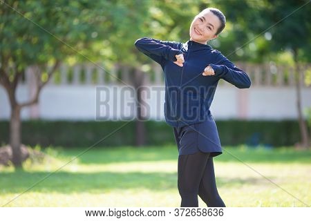 Portrait Of Asian Woman Wearing Earphones Listening To Music Was Sick With Fever At Park. Woman Exer