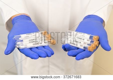Many covid-19 test tubes inhands of a doctor