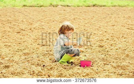 Small Kid Planting A Flower. Earth Day. New Life. Summer Farm. Happy Child Gardener. Botanic Worker.