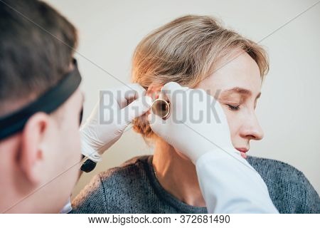 Otolaryngologist Examines Womans Ear With Dilator. Medical