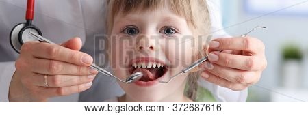 Little Girl Is Not Afraid To Show Teeth To Dentist. Prophylactic Examinations Child At Dentist. High