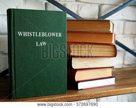 Whistleblower Law And A Stack Of Book On A Shelf.