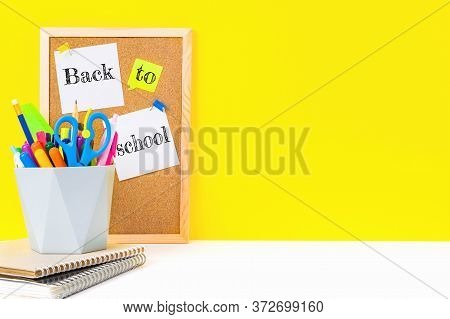 Cork Board For Notes With The Inscription Back To School On Sticky Sheets Pinned With Flags And An O