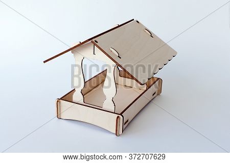 Feeding Trough For Birds With A Forage On A White Background