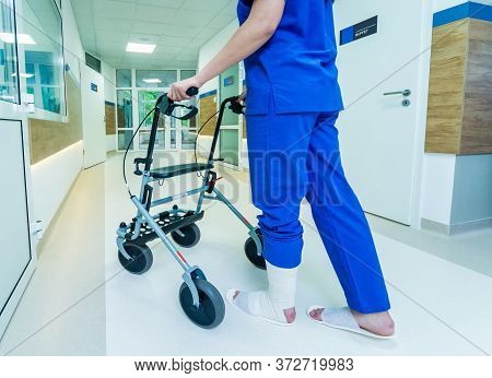 Patient On Rollator With Hand Brakes Moving In Hospital