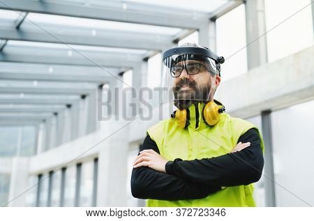 Portrait Of Worker With Protective Shield Standing At The Airport.