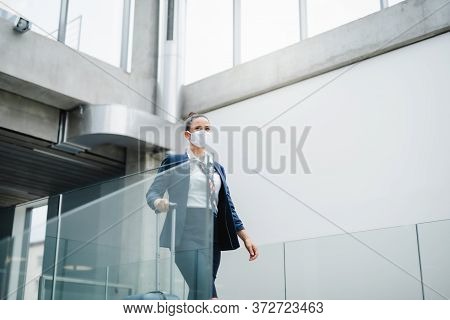 Portrait Of Attractive Flight Attendant With Suitcase Walking On Airport.