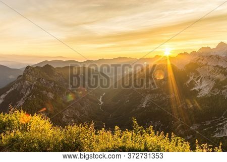 Amazing Sunrise In The Mountains. Backlight Sunlight With Beautiful Lens Flares And Sunbeams. Julian