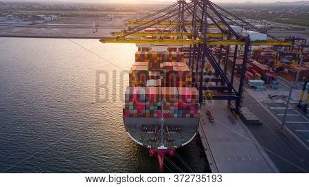 Crane Loanding Cargo Container To Container Ship In The International Terminal Yard Port  Concept Fr