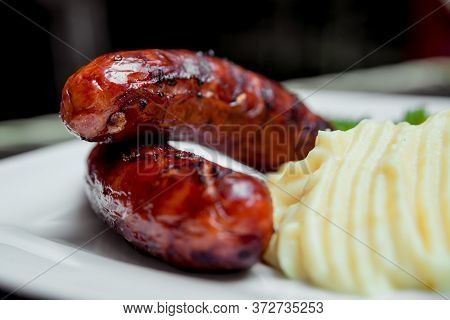 Potatoe With Sousages On The White Plate