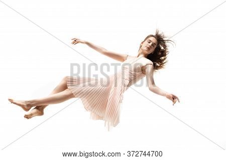 Mid-air Beauty Cought In Moment. Full Length Shot Of Attractive Young Woman Hovering In Air And Keep