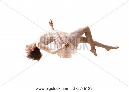 Mid-air Beauty Cought In Moment. Full Length Shot Of Attractive Young Woman Hovering In Air And Keep