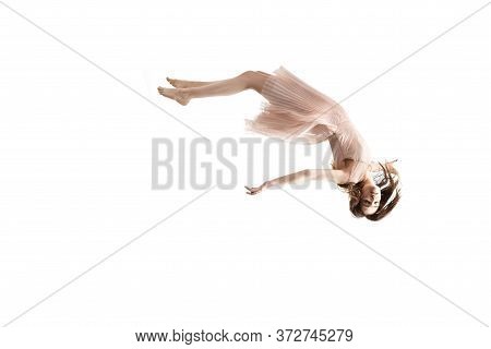 Mid-air Beauty Cought In Moment. Full Length Shot Of Attractive Young Woman Hovering In Air And Keep