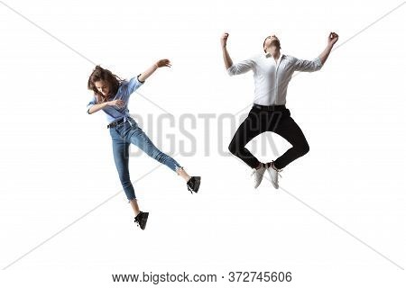Mid-air Beauty Cought In Moment. Full Length Shot Of Attractive Young Woman And Man Hovering In Air 