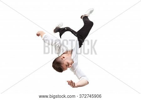 Mid-air Beauty Cought In Moment. Full Length Shot Of Young Man Hovering In Air And Keeping Eyes Clos