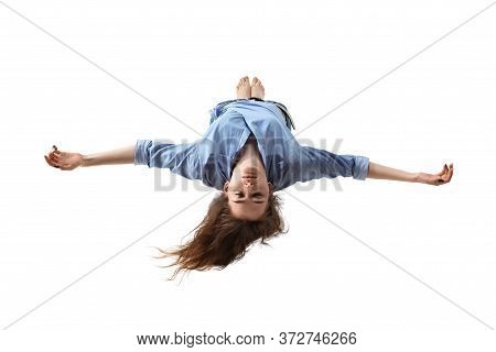Mid-air Beauty Cought In Moment. Full Length Shot Of Attractive Young Woman Hovering In Air And Keep