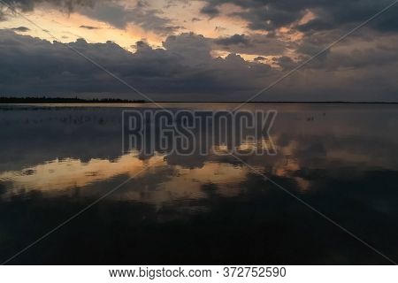 The Sky Is In Zagon With Clouds Above The Pond. Sunset Time.