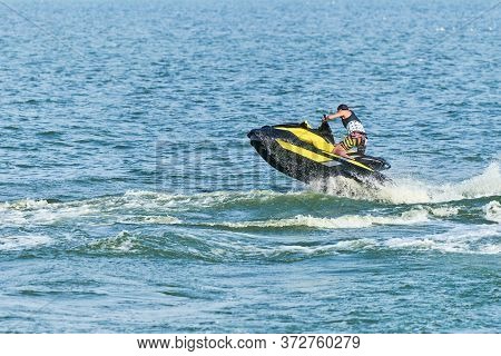 Man On Water Scooter. Summer Vacation On Personal Watercraft In Tropical Sea. Young Guy Sea Riding H