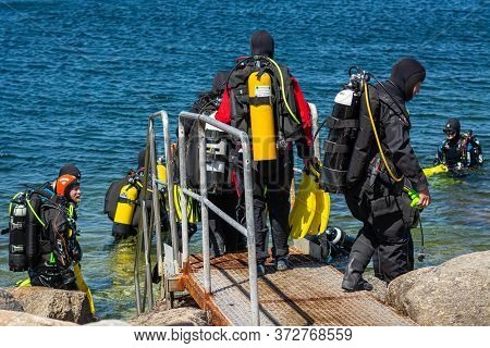Malmö, Sweden - June 14, 2020: Scuba Divers Enters The Water For A Scuba Dive In The Ocean