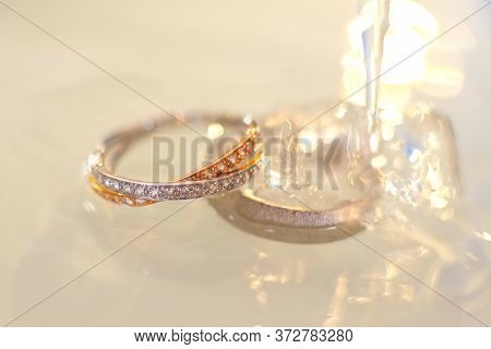 Close-up Of Two Wedding Rings In The Water.