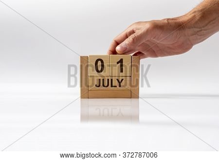 July 1 1St First. Day 1 Of Month, Handmade Wood Cube Calendar On White Glossy Background With Reflec