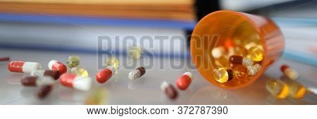 Close-up Of Tablets On Table. Worker Taking Medication On Workplace. Vitamins And Sedatives On Desk.