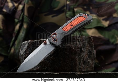 Knife For Emergency Situations On A Stone. Military Uniform And Knife.