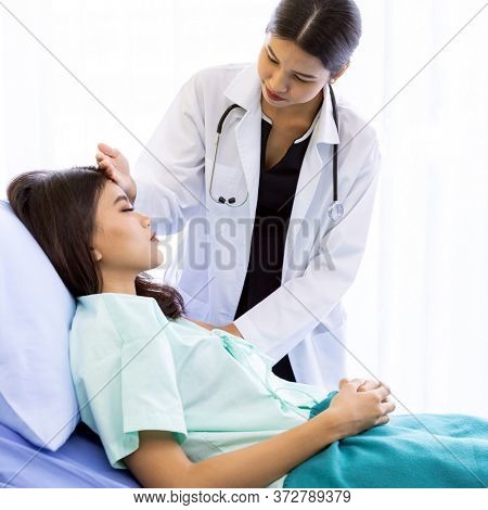 Asian Doctor make routine health check with patient in hospital ward