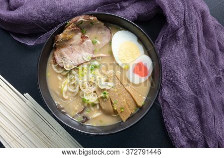 Delicious Tonkotsu Ramen, Japanese Noodle In Pork Bone Based Soup Topped With Chashu Pork, Boiled Eg
