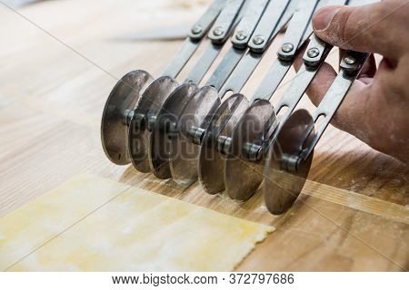 Chef Rolling Dough With A Pasta Machine. Pasta Maker Machine.