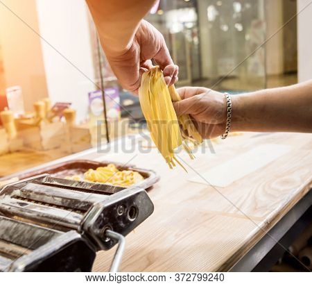 Chef Rolling Dough With A Pasta Machine. Pasta Maker Machine.