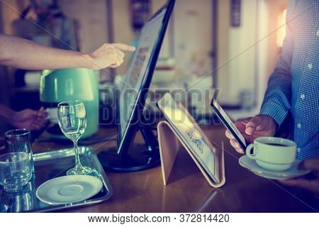 Selective Focus To Tablet And Blurry Customer Using Smart Phone Scan Qr Code On Tablet To Payment Wi
