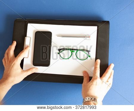 Hands Reach For Laptop, Tablet With Paper, Mobile Phone, Glasses And Pen