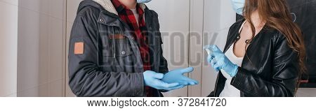 View Of Couple In Medical Masks And Latex Gloves Using Antiseptic Spray, Horizontal Image