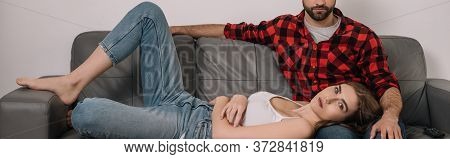 Image Of Depressed Young Couple On Sofa At Home During Quarantine