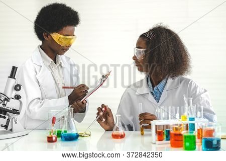 Two African American Cute Little Boy And Girl Student Child Learning Research And Doing A Chemical E