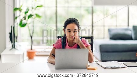 School Kid Little Girl Learning And Looking At Laptop Computer Making Homework Studying Knowledge Wi