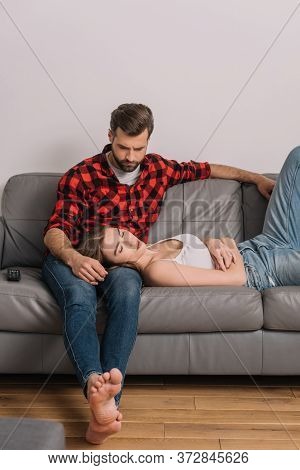 Young Couple On Sofa At Home During Quarantine